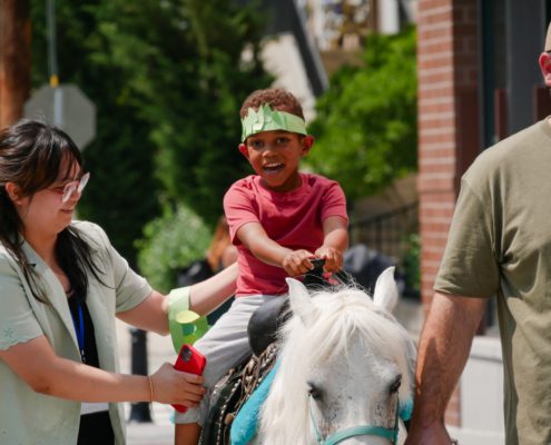 A boy is riding a horse.