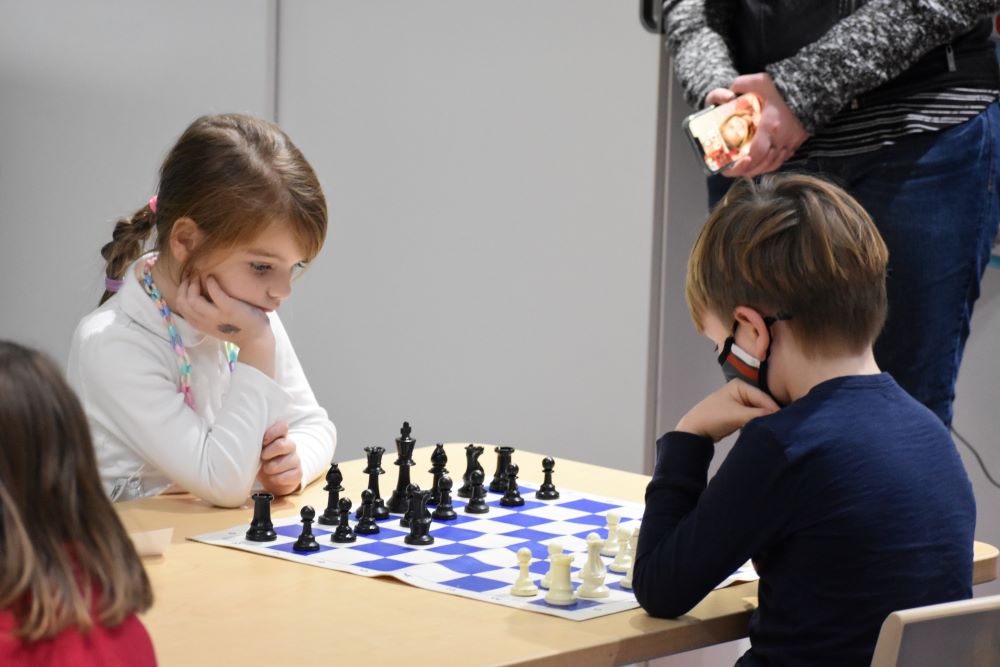 Two students are playing chess in the Afterschool class. 