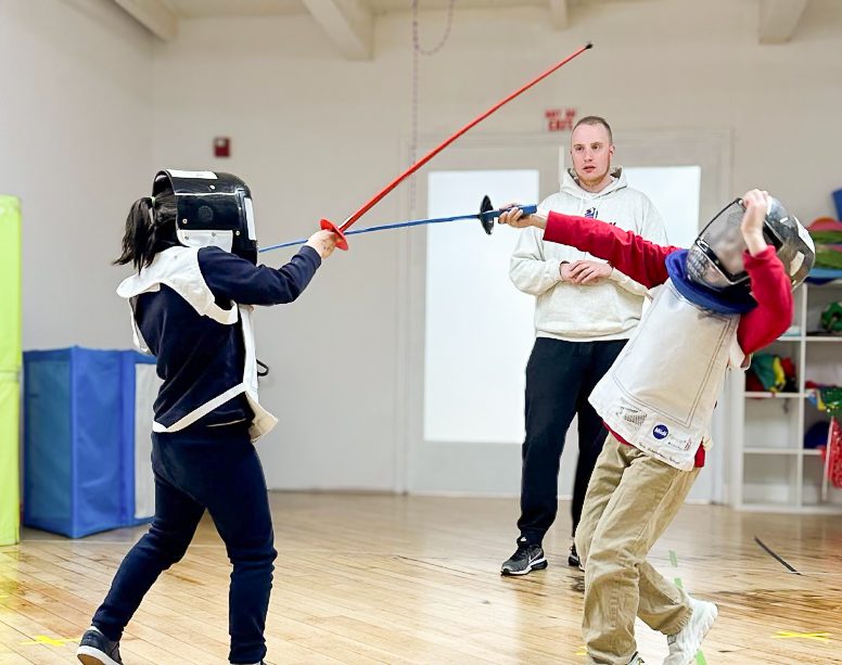 Two students practice fencing in Afterschool class. 