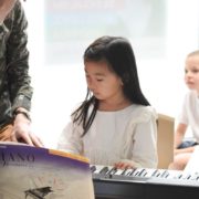 A girl is playing piano in Tessa Afterschool private lesson.