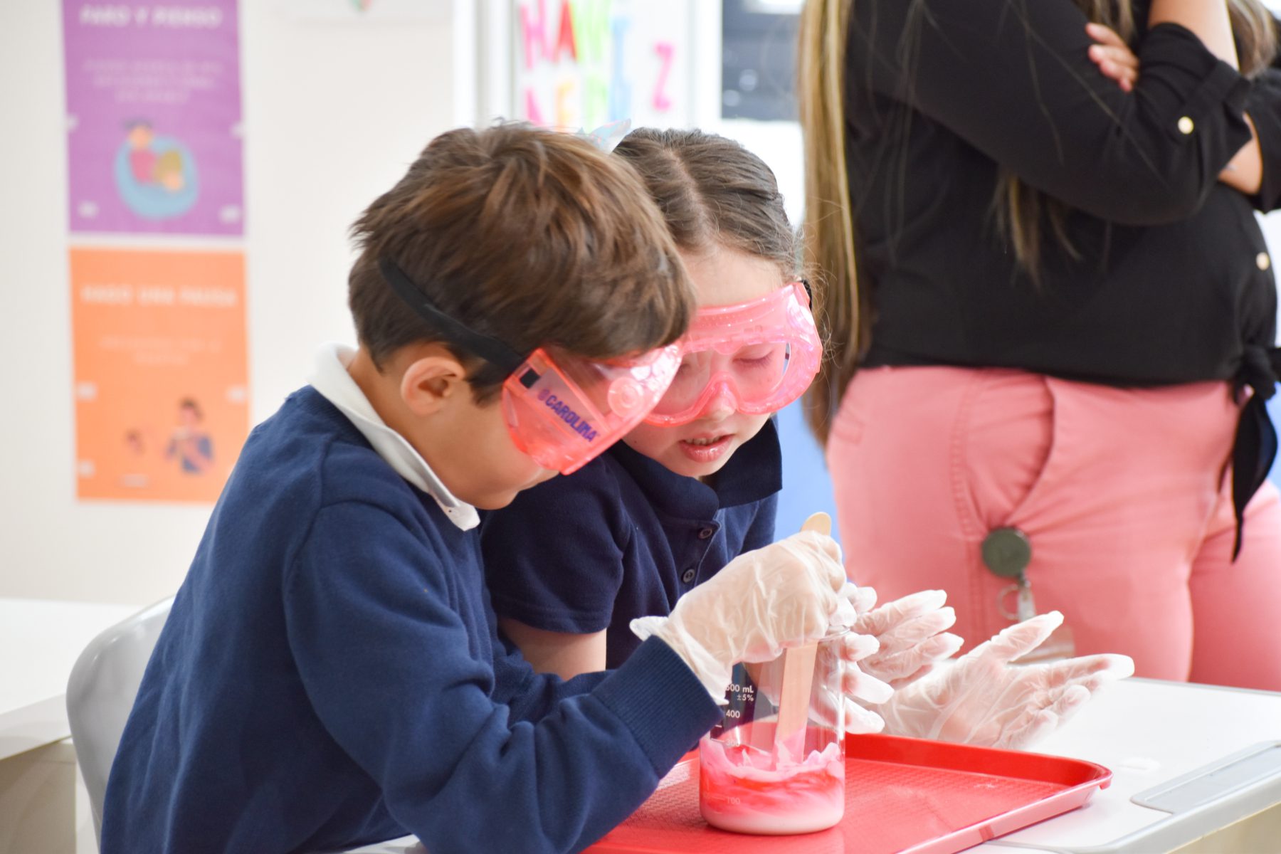 Two students observe the chemical reaction in Afterschool STEM program. 