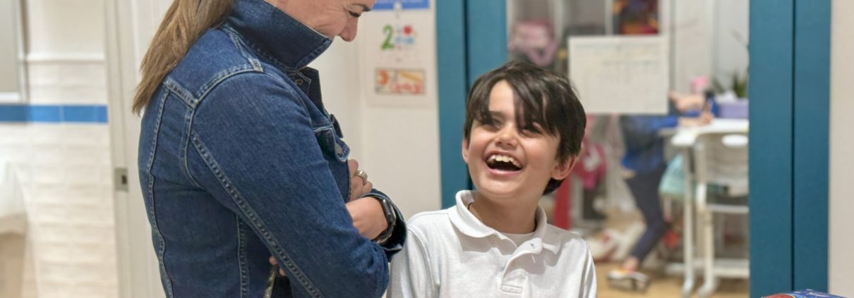 A parent engages in his son's sharing of his learning in IB PYP.