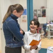 A parent engages in his son's sharing of his learning in IB PYP.