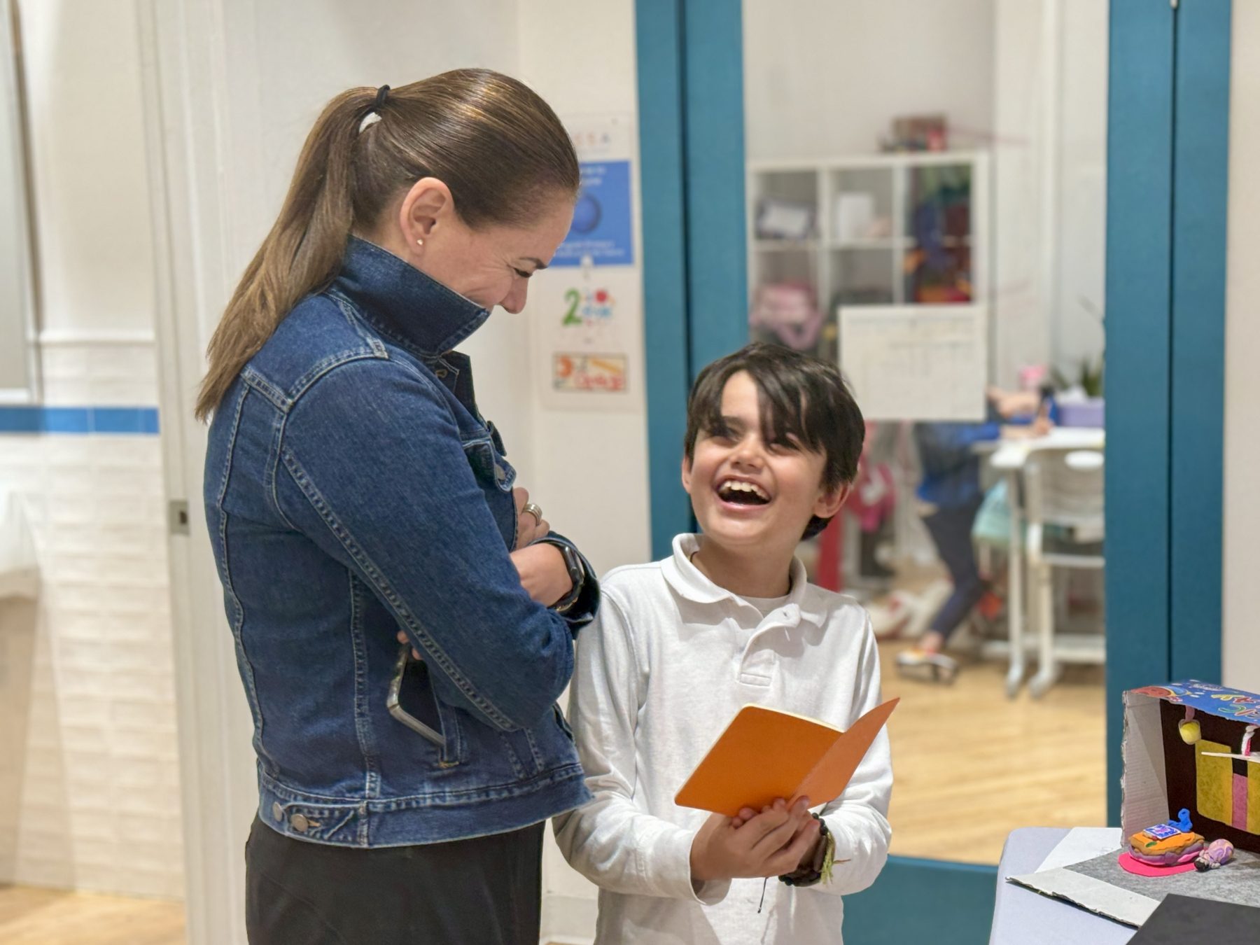 A parent engages in his son's sharing of his learning in IB PYP. 