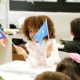 A girl from the primary class waving two national flags.