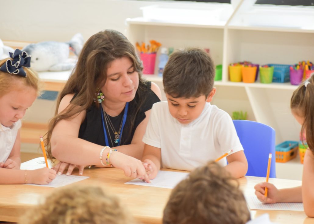 A Spanish immersion school student learning with his teacher