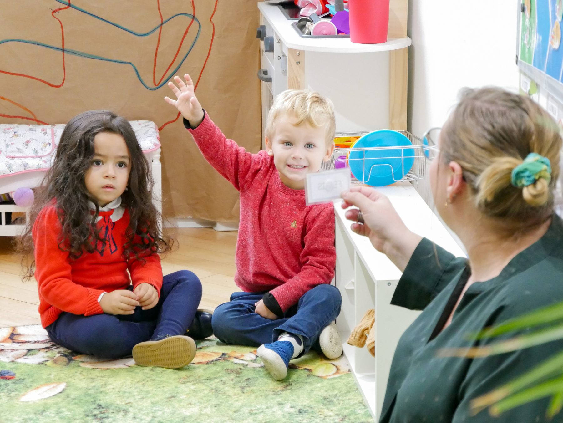 Two French Track toddlers actively engage in bilingual learning. 