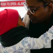 A boy hugging his father after his performance in nursery school