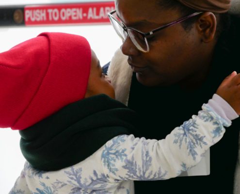 A boy hugging his father after his performance in nursery school