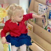 A girl in Tessa International School's Nursery French program picking the book to read