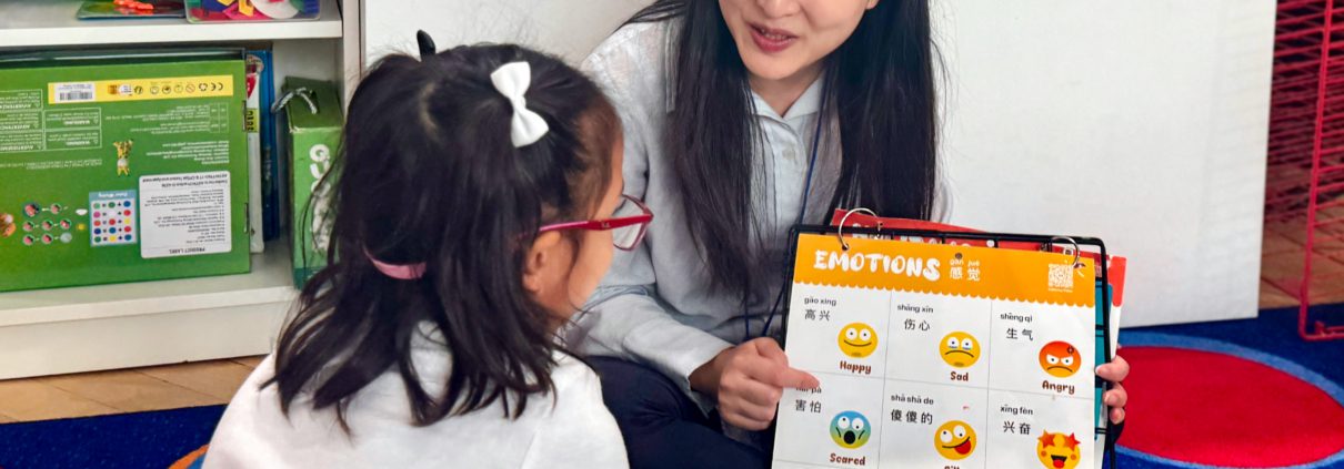A preschool teacher is teaching how to express different emotions in Mandarin.