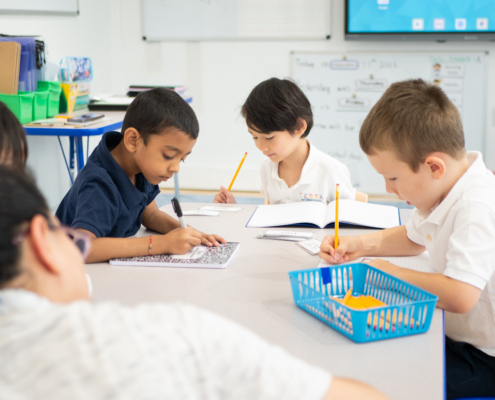 First Graders at Tessa International School focused on their writing task.